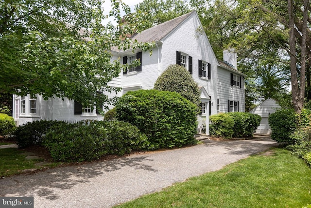 114 Bellemore Rd, Baltimore, MD 21210 - view of front facade with a chimney, brick siding, and a detached garage