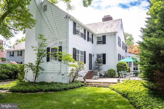 114 Bellemore Rd, Baltimore, MD 21210 - back of property featuring a chimney and a lawn