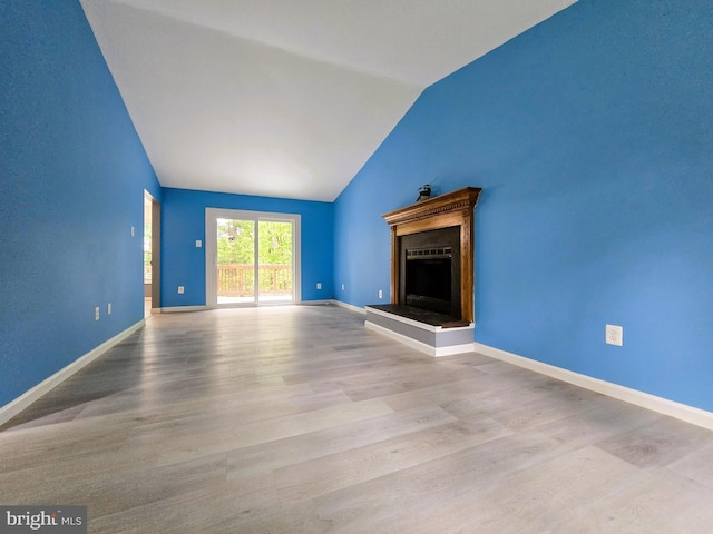 10920 Oakcrest Cir, New Market, MD 21774 - unfurnished living room with lofted ceiling, a fireplace with raised hearth, wood finished floors, and baseboards
