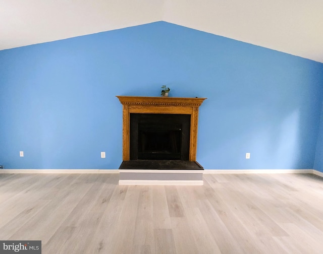 10920 Oakcrest Cir, New Market, MD 21774 - unfurnished living room with lofted ceiling, a fireplace with raised hearth, wood finished floors, and baseboards