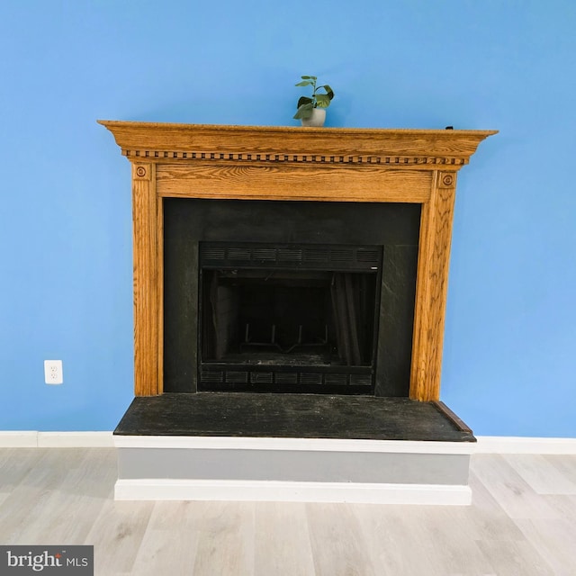 10920 Oakcrest Cir, New Market, MD 21774 - detailed view of wood finished floors, baseboards, and a fireplace with raised hearth