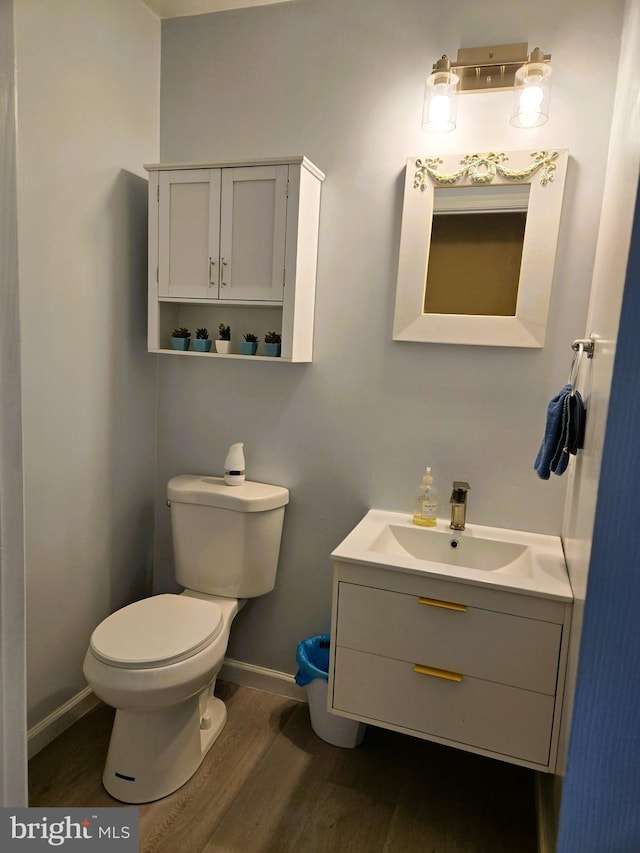 10920 Oakcrest Cir, New Market, MD 21774 - bathroom with wood finished floors, baseboards, toilet, and vanity