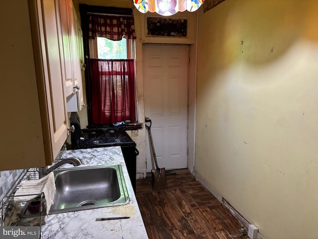 4832 N Sydenham St, Philadelphia, PA 19141 - kitchen featuring a sink, light countertops, baseboards, and black gas range oven