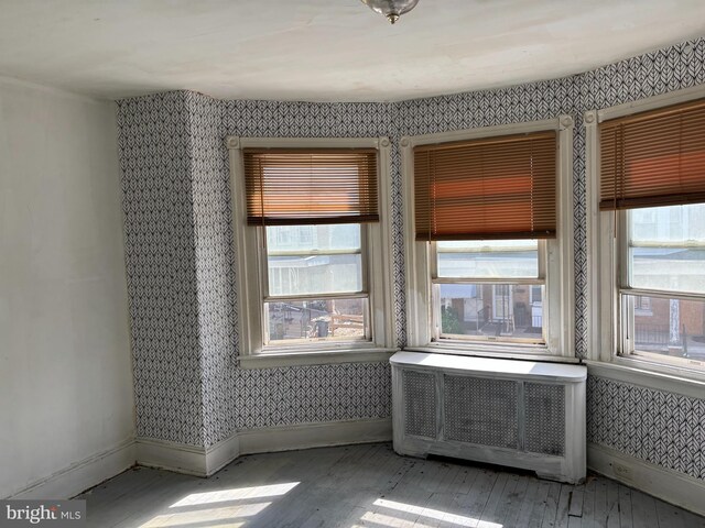 4832 N Sydenham St, Philadelphia, PA 19141 - spare room featuring wallpapered walls, baseboards, hardwood / wood-style floors, and plenty of natural light