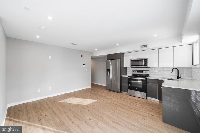2639 Cecil B Moore Ave, Philadelphia, PA 19121 - kitchen featuring stainless steel appliances, a sink, light countertops, light wood-type flooring, and baseboards