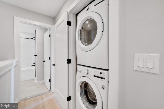2639 Cecil B Moore Ave, Philadelphia, PA 19121 - laundry area with stacked washing machine and dryer and light wood-style flooring