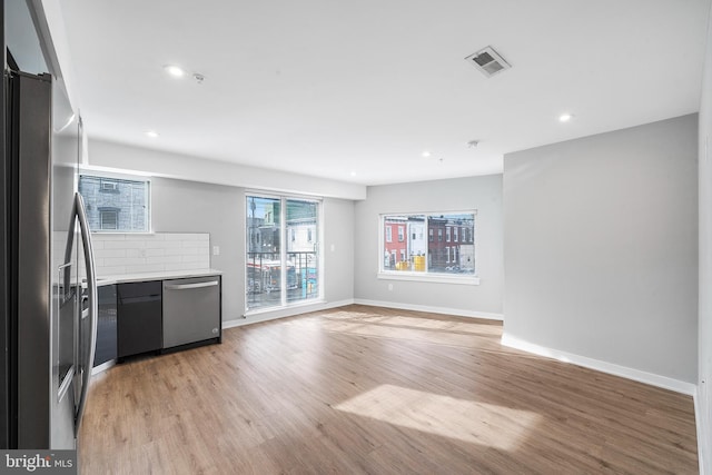 2639 Cecil B Moore Ave, Philadelphia, PA 19121 - unfurnished living room with light wood-style floors, a barn door, recessed lighting, and baseboards