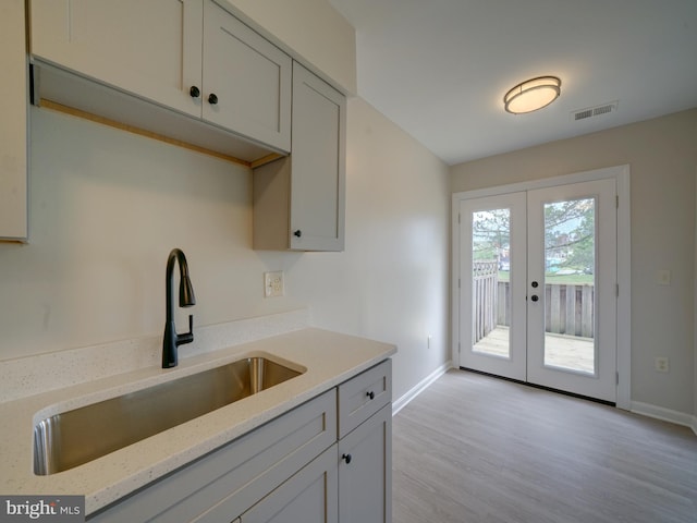 9309 Player Dr Unit 116, Laurel, MD 20708 - kitchen with a sink, baseboards, french doors, and light wood-style floors
