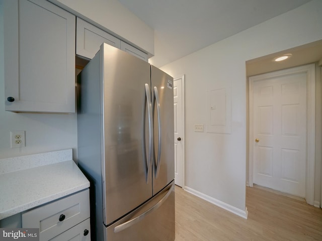 9309 Player Dr Unit 116, Laurel, MD 20708 - kitchen featuring freestanding refrigerator, baseboards, light wood-type flooring, electric panel, and gray cabinets