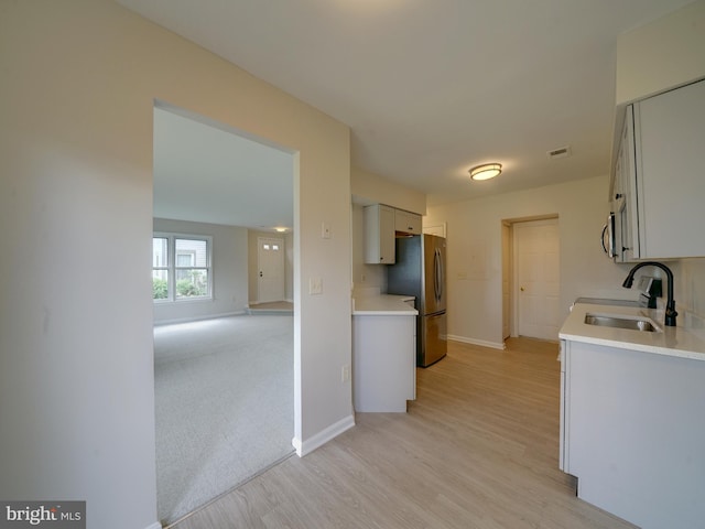 9309 Player Dr Unit 116, Laurel, MD 20708 - kitchen featuring stainless steel appliances, a sink, light wood-type flooring, and light countertops