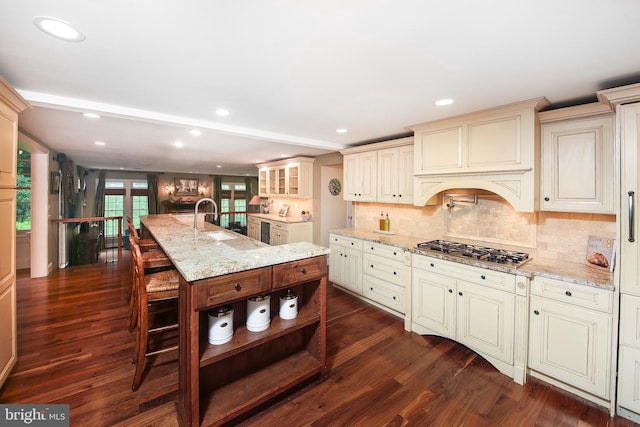 3195 Pelham Pl, Doylestown, PA 18902 - kitchen with cream cabinetry, stainless steel gas cooktop, a sink, dark wood-style flooring, and open shelves