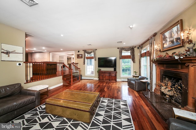 3195 Pelham Pl, Doylestown, PA 18902 - living room with hardwood / wood-style flooring, stairs, a fireplace, a baseboard heating unit, and recessed lighting