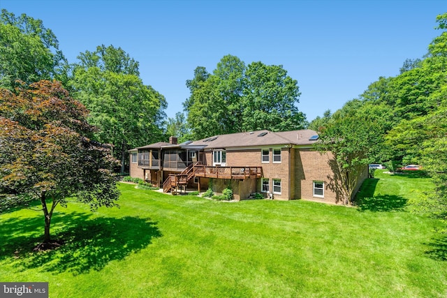 10060 Hampton Rd, Fairfax Station, VA 22039 - back of house with a sunroom, stairs, a wooden deck, a yard, and brick siding
