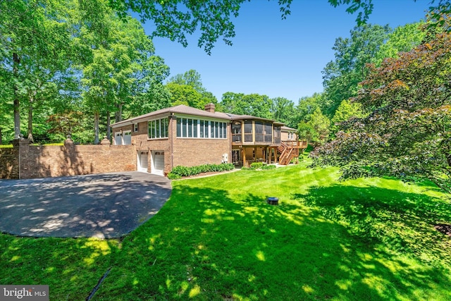 10060 Hampton Rd, Fairfax Station, VA 22039 - rear view of property with a sunroom, a garage, stairs, brick siding, and a chimney