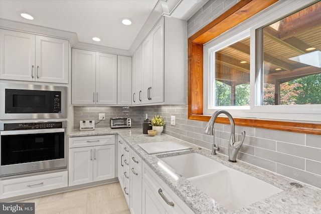 10060 Hampton Rd, Fairfax Station, VA 22039 - kitchen featuring stainless steel oven, built in microwave, tasteful backsplash, plenty of natural light, and recessed lighting