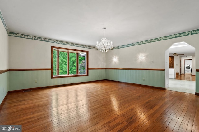 10060 Hampton Rd, Fairfax Station, VA 22039 - unfurnished room with washer / dryer, hardwood / wood-style flooring, wainscoting, a chandelier, and arched walkways