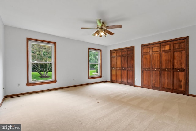 10060 Hampton Rd, Fairfax Station, VA 22039 - unfurnished bedroom with multiple windows, carpet floors, two closets, and ceiling fan
