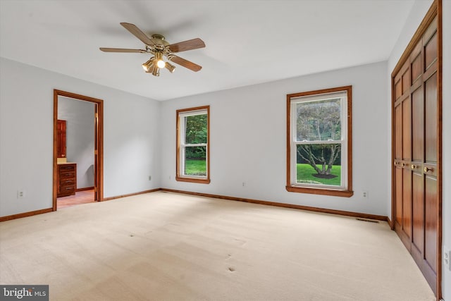 10060 Hampton Rd, Fairfax Station, VA 22039 - unfurnished bedroom featuring multiple windows, light carpet, ensuite bathroom, and ceiling fan