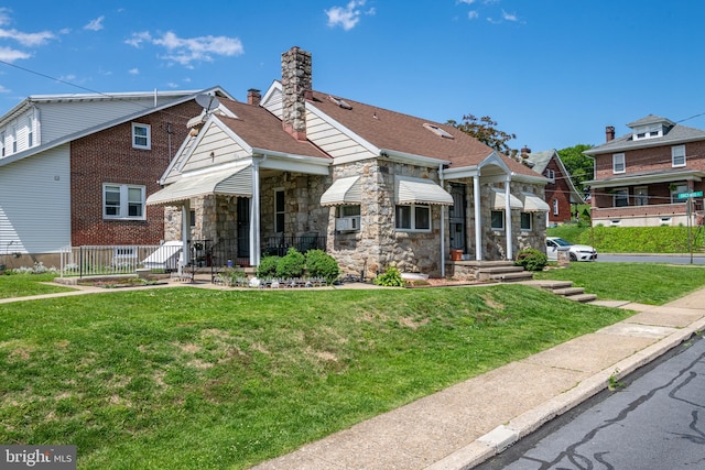 935 Grove St, Reading, PA 19605 - view of front of house featuring stone siding, a front lawn, and a chimney