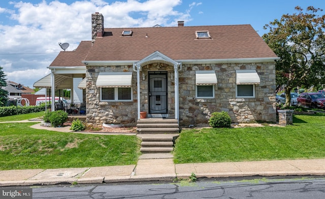 935 Grove St, Reading, PA 19605 - view of front of house with stone siding, a front lawn, and a chimney