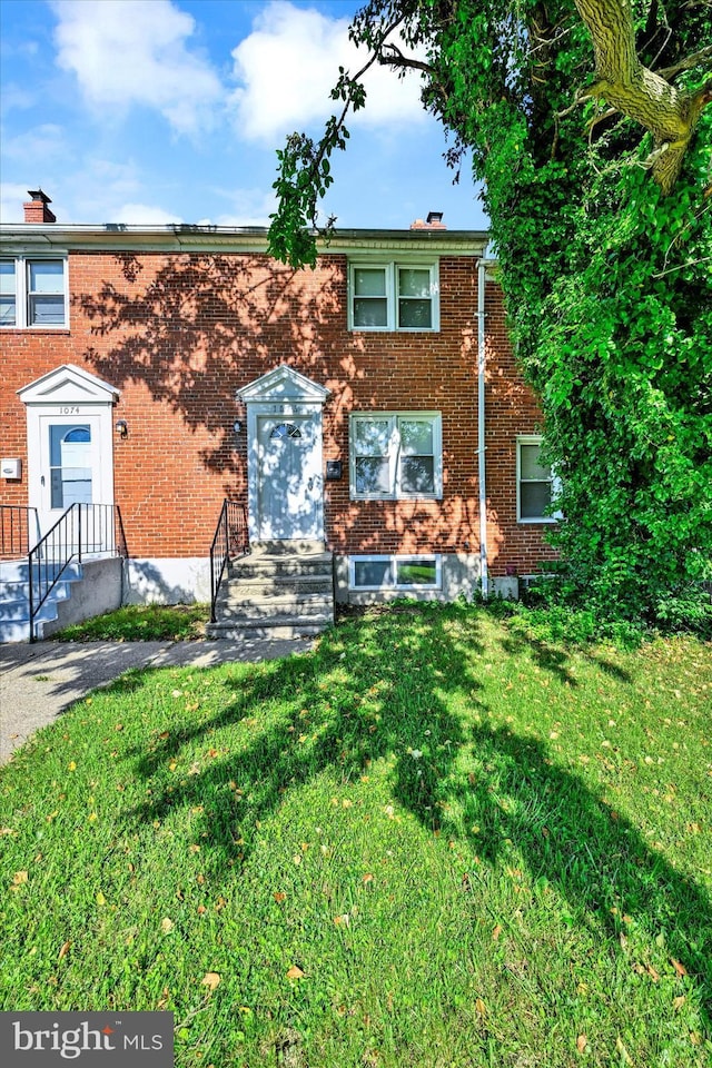 1076 Tunbridge Rd, Baltimore, MD 21212 - townhome / multi-family property featuring brick siding and a front lawn
