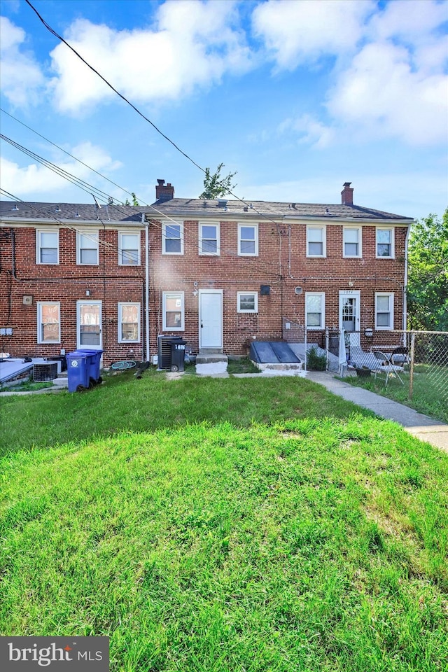 1076 Tunbridge Rd, Baltimore, MD 21212 - rear view of property with a chimney, cooling unit, and brick siding