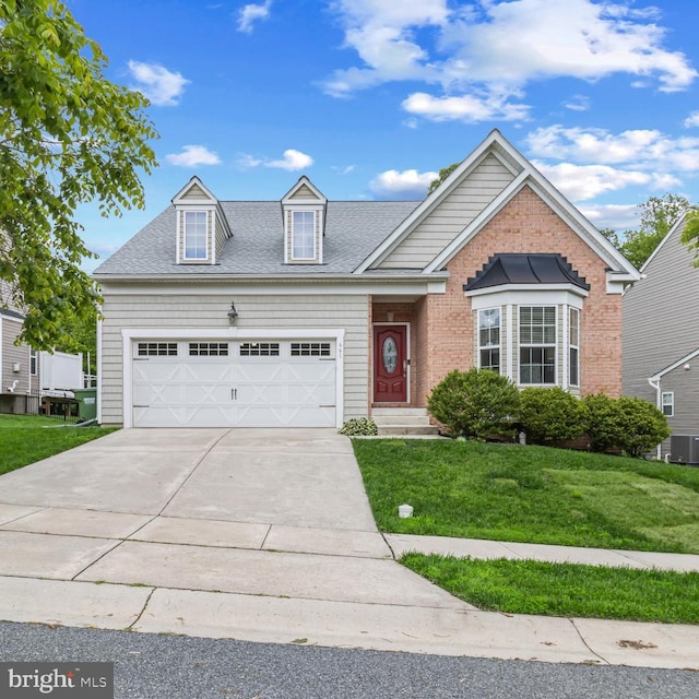 661 Claiborne Road, North East, MD 21901 - view of front of property with a front lawn, an attached garage, concrete driveway, central AC, and a shingled roof