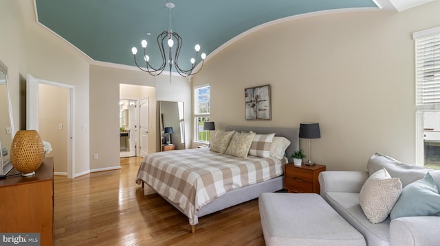 661 Claiborne Road, North East, MD 21901 - bedroom featuring wood finished floors, a chandelier, connected bathroom, lofted ceiling, and baseboards
