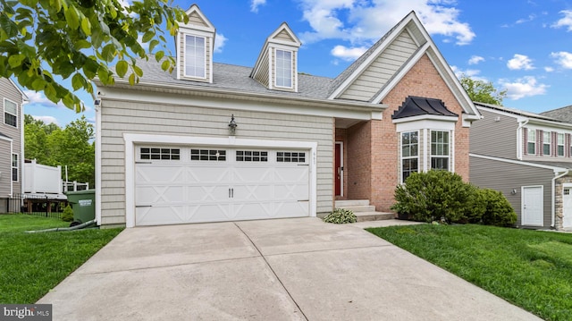 661 Claiborne Road, North East, MD 21901 - view of front of house with driveway, a front yard, a shingled roof, a garage, and brick siding