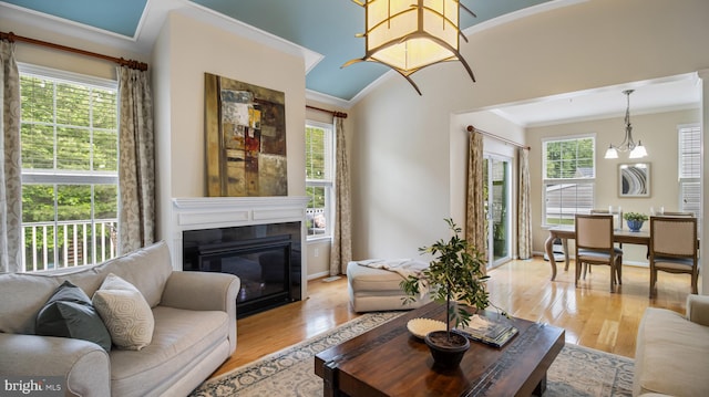 661 Claiborne Road, North East, MD 21901 - living room with ornamental molding, light wood-type flooring, a glass covered fireplace, and baseboards