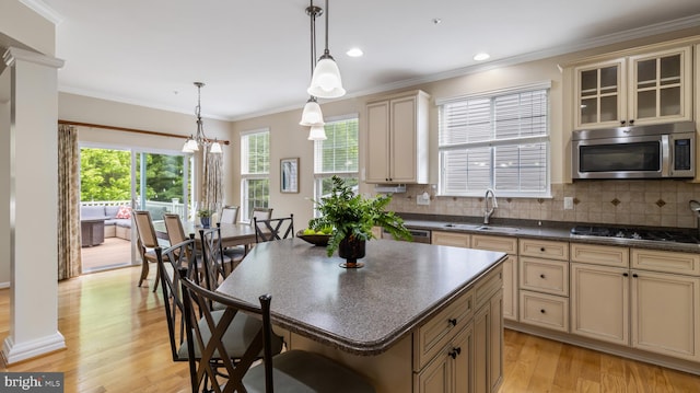 661 Claiborne Road, North East, MD 21901 - kitchen featuring stainless steel microwave, cream cabinetry, a sink, black stovetop, and dark countertops