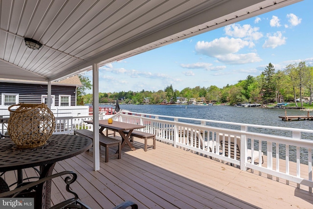 34 S Lake Dr, Lake Harmony, PA 18624 - deck with a water view, outdoor dining area, a boat dock, and view of scattered trees