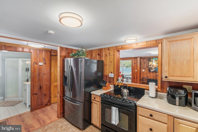 34 S Lake Dr, Lake Harmony, PA 18624 - kitchen featuring appliances with stainless steel finishes, light countertops, light brown cabinetry, wooden walls, and light tile patterned floors