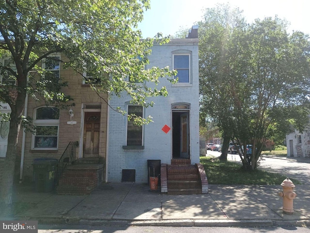 109 S Schroeder St, Baltimore, MD 21223 - view of front of home with brick siding and a chimney