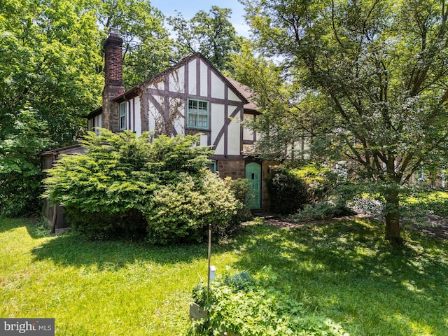 213 Rices Mill Rd, Wyncote, PA 19095 - tudor home with a front lawn, a chimney, and stucco siding