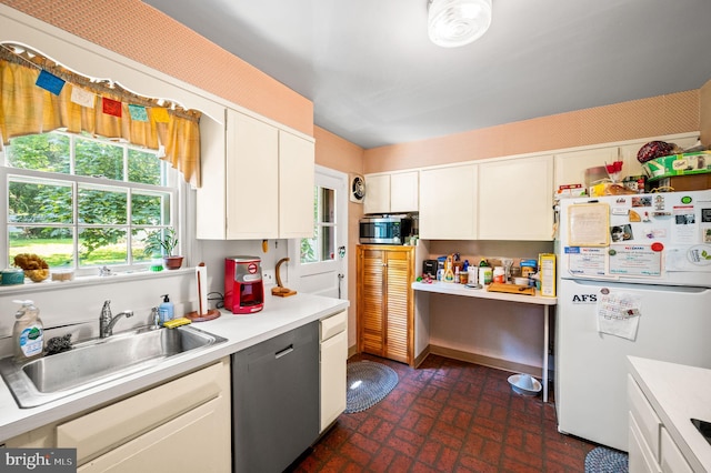 213 Rices Mill Rd, Wyncote, PA 19095 - kitchen with stainless steel appliances, light countertops, brick patterned flooring, and white cabinetry