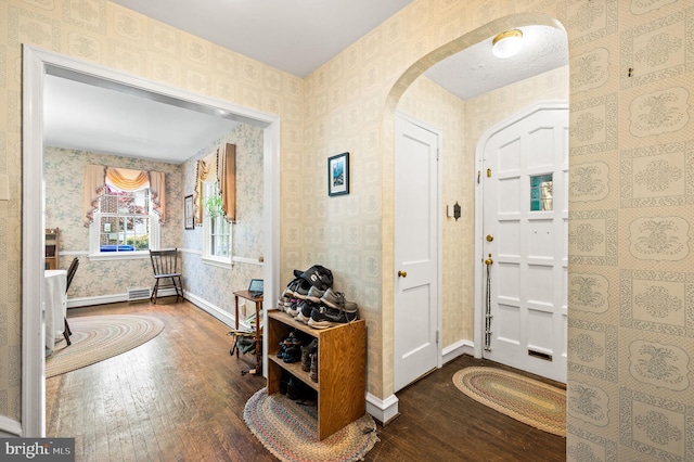 213 Rices Mill Rd, Wyncote, PA 19095 - foyer entrance with hardwood / wood-style flooring, arched walkways, and wallpapered walls