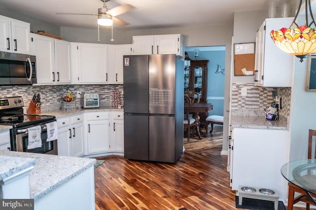 9348 Amaryllis Ave, Manassas, VA 20110 - kitchen with stainless steel appliances, ceiling fan, white cabinetry, dark wood-type flooring, and decorative backsplash