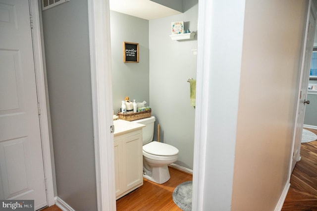 9348 Amaryllis Ave, Manassas, VA 20110 - half bathroom featuring toilet, wood finished floors, vanity, and baseboards