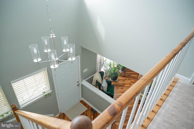9348 Amaryllis Ave, Manassas, VA 20110 - staircase with a chandelier, a high ceiling, and baseboards
