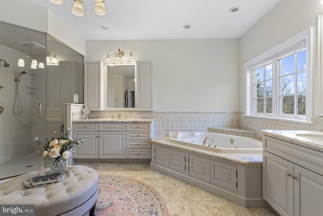 7 Chaville Way, Greenville, DE 19807 - bathroom featuring a stall shower, two vanities, a bath, and tile patterned flooring
