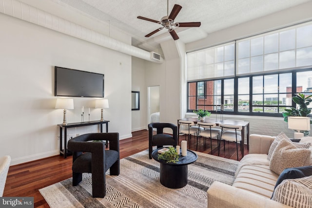 2429 Locust St Unit 504, Philadelphia, PA 19103 - living area featuring a high ceiling, wood finished floors, baseboards, ceiling fan, and a textured ceiling
