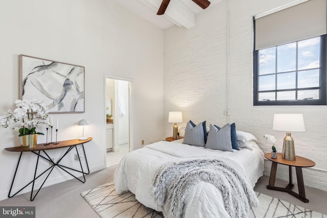 2429 Locust St Unit 504, Philadelphia, PA 19103 - bedroom with carpet floors, beamed ceiling, brick wall, a towering ceiling, and ensuite bathroom
