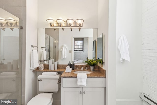 2429 Locust St Unit 504, Philadelphia, PA 19103 - bathroom with a baseboard heating unit, vanity, a shower stall, and toilet