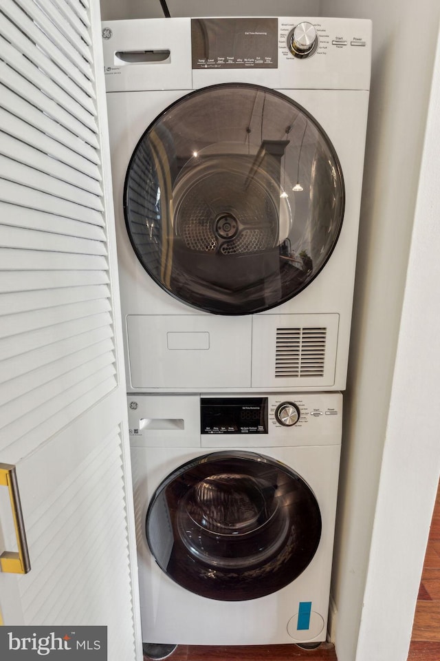 2429 Locust St Unit 504, Philadelphia, PA 19103 - laundry area featuring stacked washer / dryer and wood finished floors