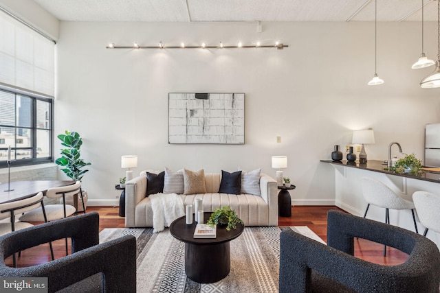 2429 Locust St Unit 504, Philadelphia, PA 19103 - living area with wood finished floors, baseboards, and track lighting