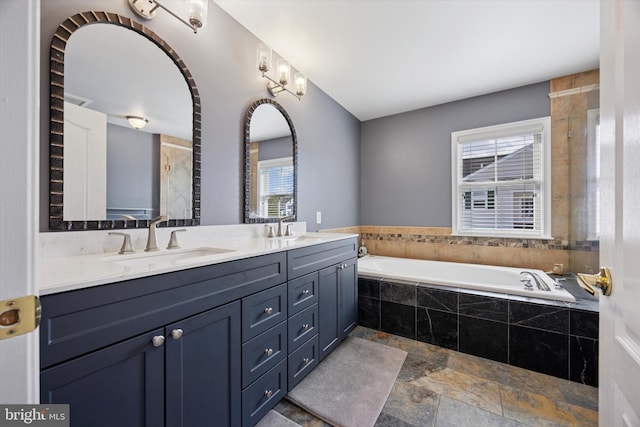 246 Honey Hollow Ln, Chalfont, PA 18914 - bathroom featuring a garden tub, double vanity, and stone finish flooring
