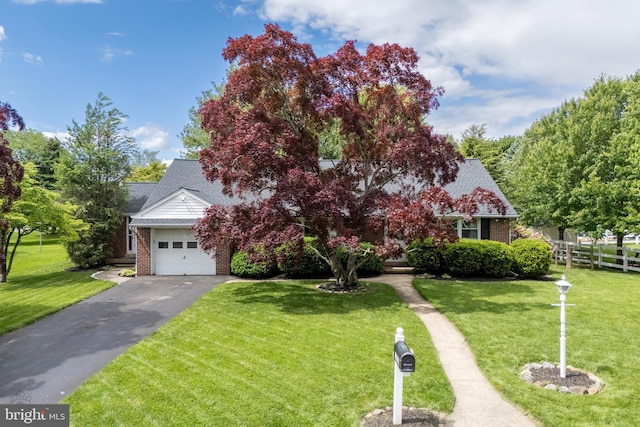 1050 Westgate Dr, Bethlehem, PA 18017 - view of property hidden behind natural elements featuring brick siding, asphalt driveway, a garage, and a shingled roof