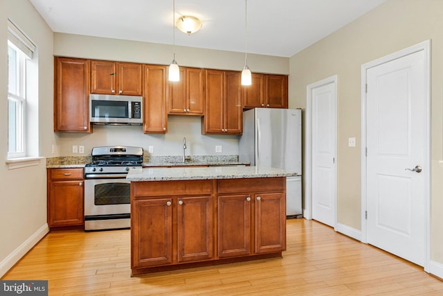 3318 Sherman Ave NW Unit 104, Washington, DC 20010 - kitchen with appliances with stainless steel finishes, a sink, light wood-type flooring, and healthy amount of natural light