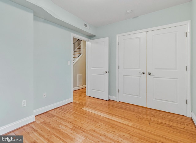 3318 Sherman Ave NW Unit 104, Washington, DC 20010 - unfurnished bedroom with baseboards, light wood-type flooring, and a closet